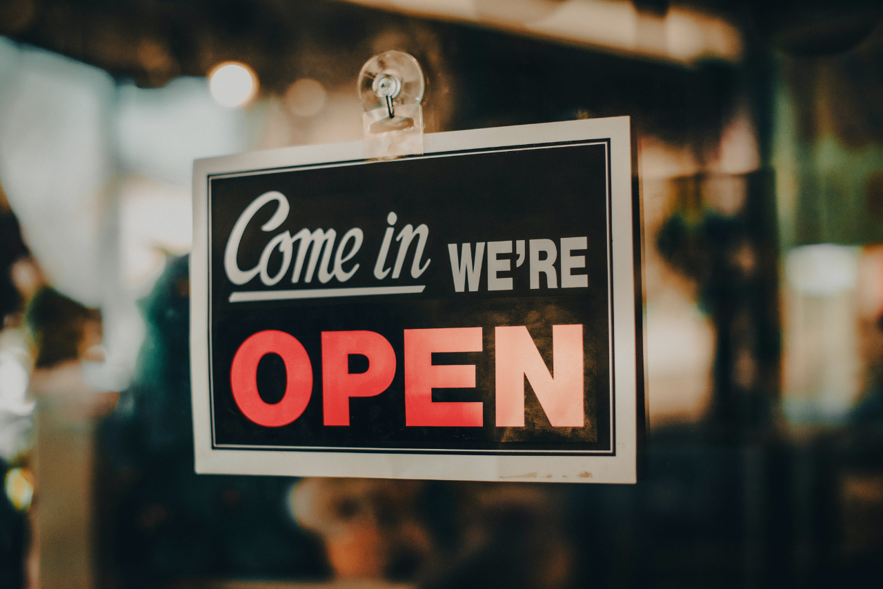 Sign in a window reading "Come In, We're Open"