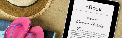 eReader next to flip flops and summer hat
